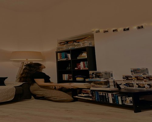 A person sitting calmly in a cozy reading corner with a warm cup of tea