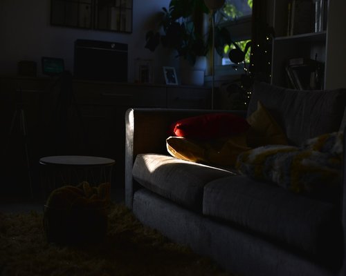 Comfortable pillows and bed in a dimly lit room